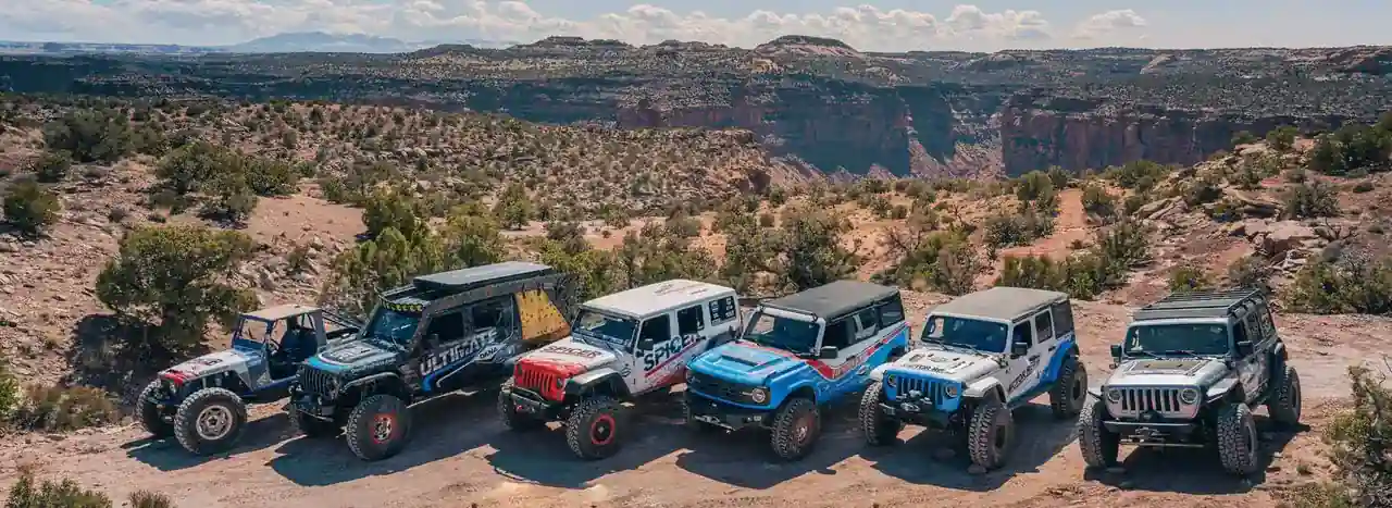 Dana and Spicer-equipped Jeep and Bronco off-road builds on a desert canyon rim